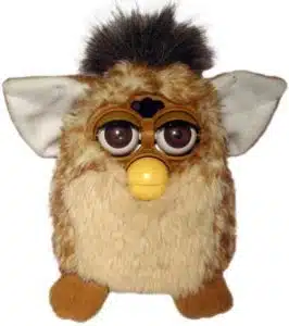 A brown and white electronic toy with large eyes, a yellow beak, and pointed ears, resembling a furry creature—brought to you by Georgia Probate Law Group - Your Professional Probate Attorney.